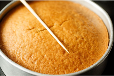 Eggless vanilla sponge cake in a tin